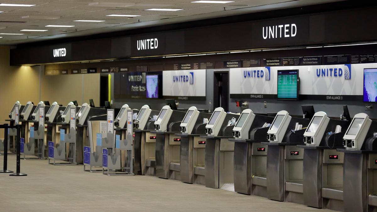 Empty United Airlines ticket machines are shown at the Tampa International Airport in Tampa, Fla., on April 24, 2020 (Chris O'Meara/AP Photo)