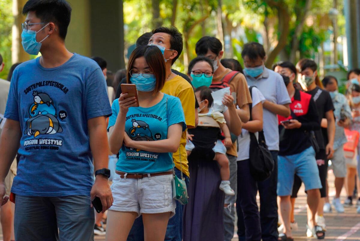 People line up to vote in an unofficial primary for pro-democracy candidates ahead of legislative elections in September, in Hong Kong on July 12, 2020. (Vincent Yu/AP Photo)