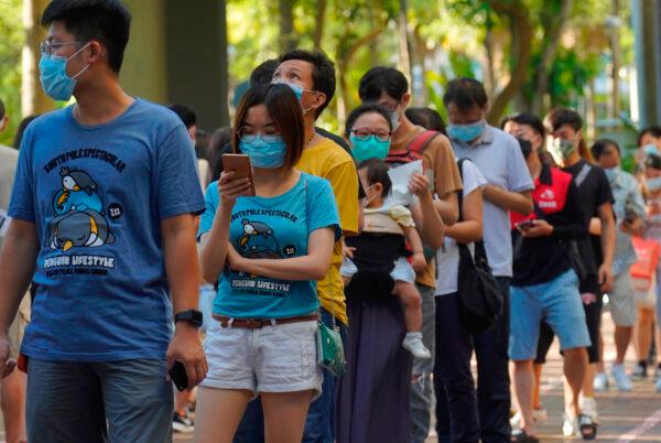 People line up to vote in an unofficial primary for pro-democracy candidates ahead of legislative elections in September, in Hong Kong on July 12, 2020. (Vincent Yu/AP Photo)