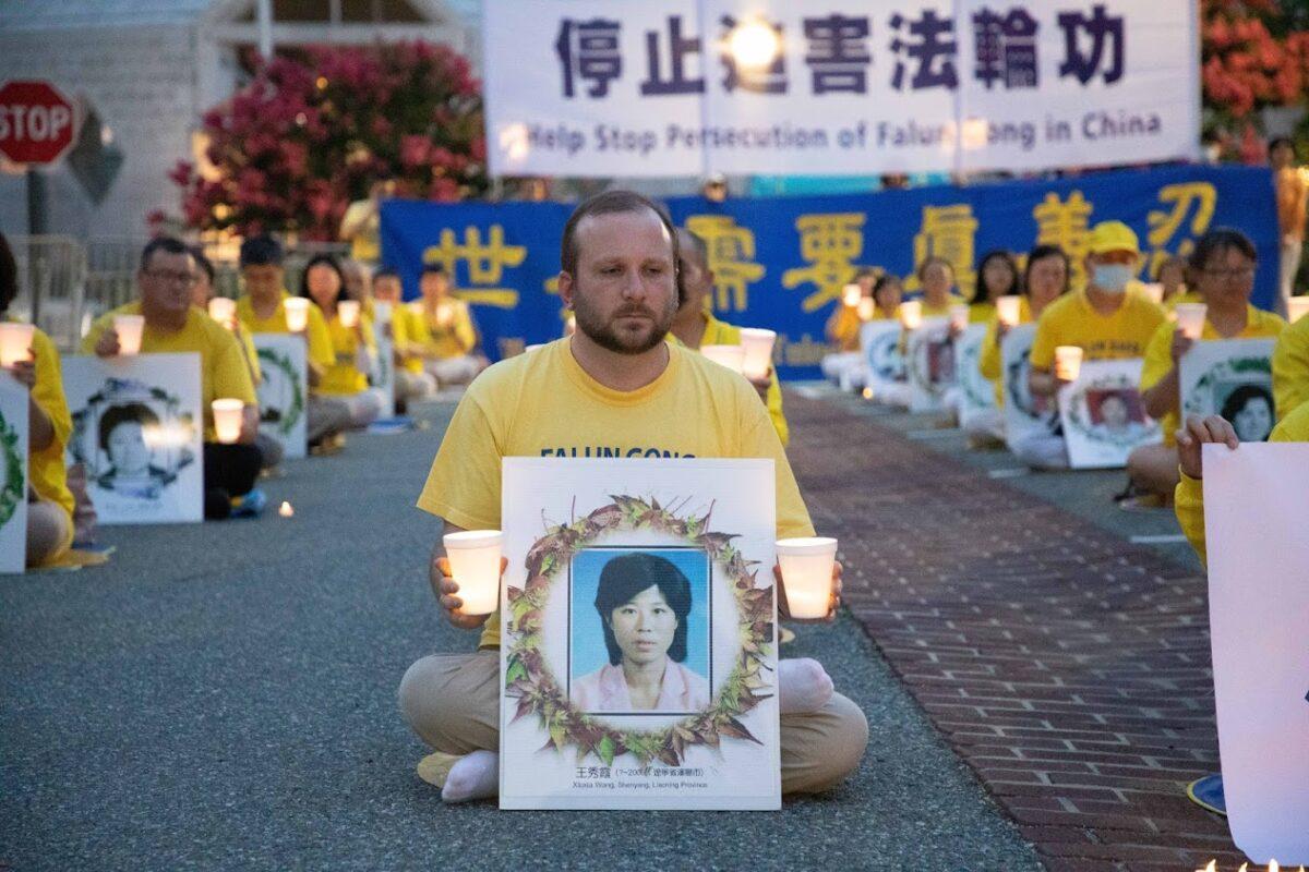 Erik Meltzer takes part in a candlelight vigil outside the Chinese Embassy in Washington on July 17, 2020. (Lynn Lin/Epoch Times)