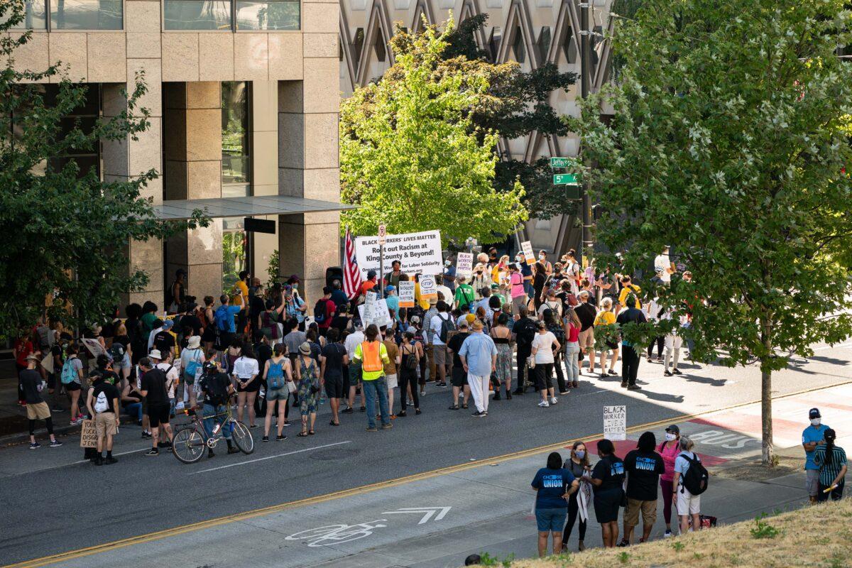 Demonstrators gather to listen to speeches during a picket and rally event outside the office of King County Executive Dow Constantine as part of the nationwide Strike For Black Lives in Seattle, Wash., on July 20, 2020. (David Ryder/Getty Images)