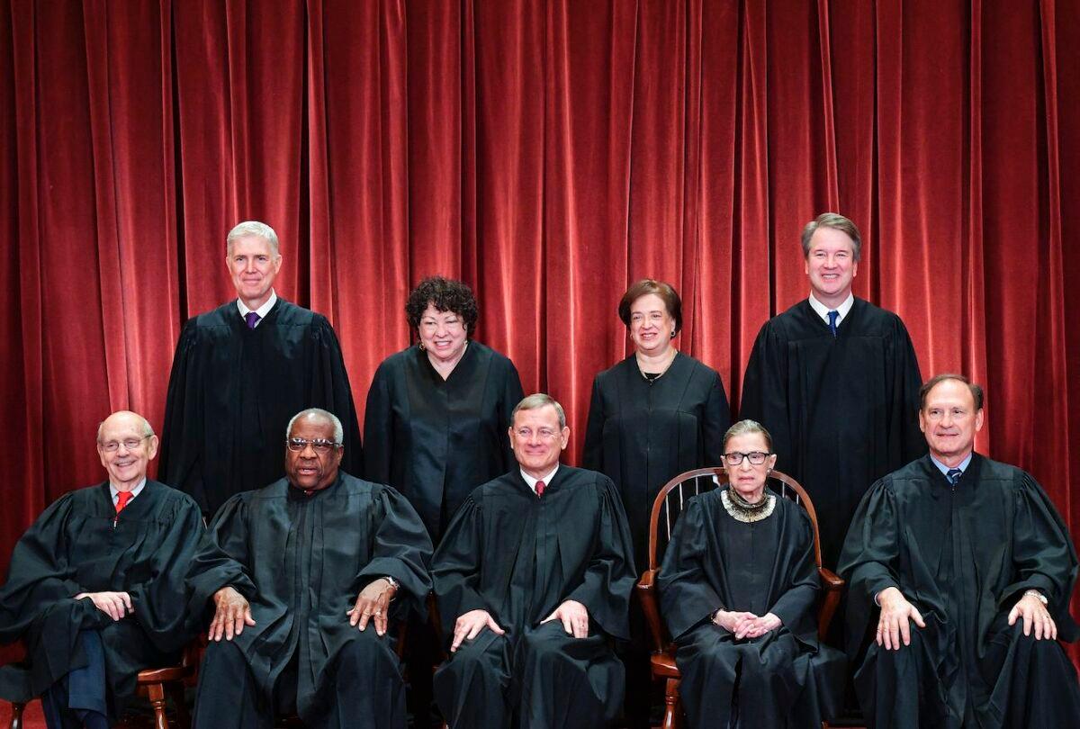 Standing from left: Associate Justice Neil Gorsuch, Associate Justice Sonia Sotomayor, Associate Justice Elena Kagan, and Associate Justice Brett Kavanaugh. Seated from left to right: Associate Justice Stephen Breyer, Associate Justice Clarence Thomas, Chief Justice John Roberts, Associate Justice Ruth Bader Ginsburg, and Associate Justice Samuel Alito. (Mandel Ngan/AFP via Getty Images)