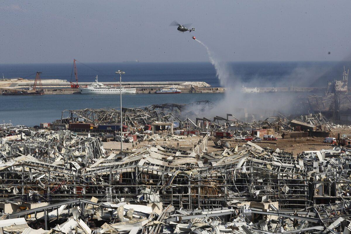A Lebanese army helicopter throw water at the scene where an explosion hit the seaport of Beirut, Lebanon, on Aug. 5, 2020. (Hussein Malla/AP Photo)