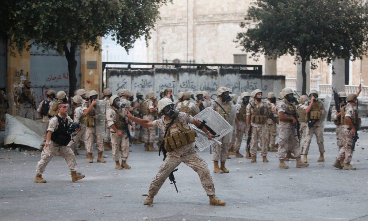 A soldier throws a stone during anti-government protests in Beirut, Lebanon, on August 8, 2020. (Marwan Tahtah/Getty Images)