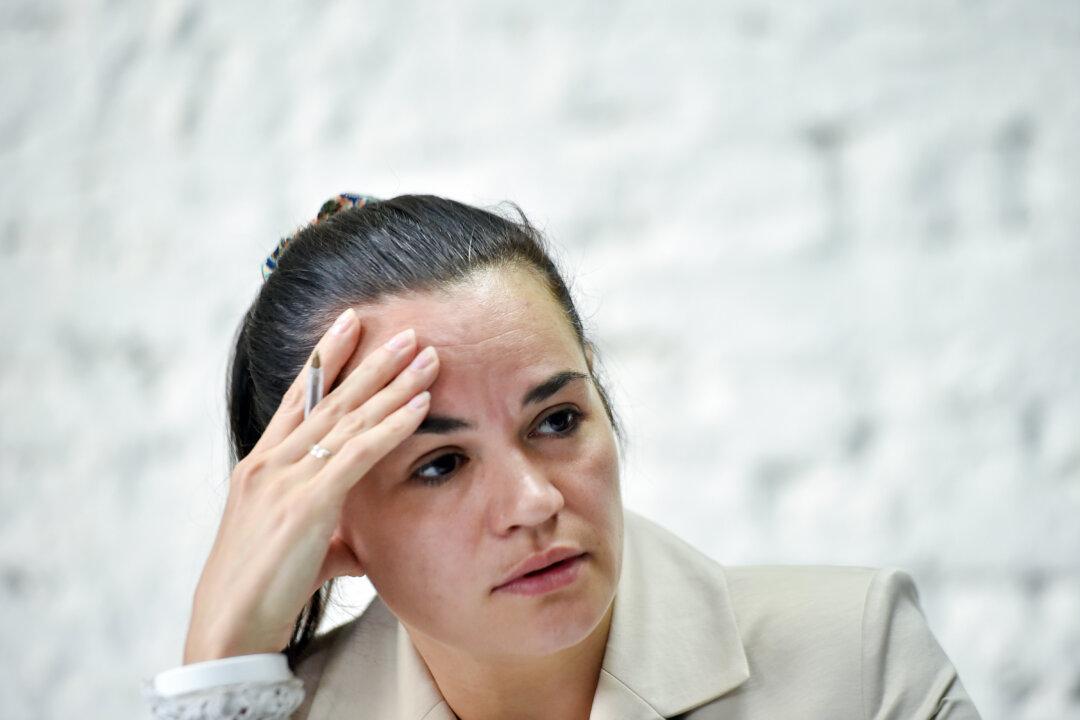 Belarusian Opposition Leader Flees Abroad After Bloody Clashes