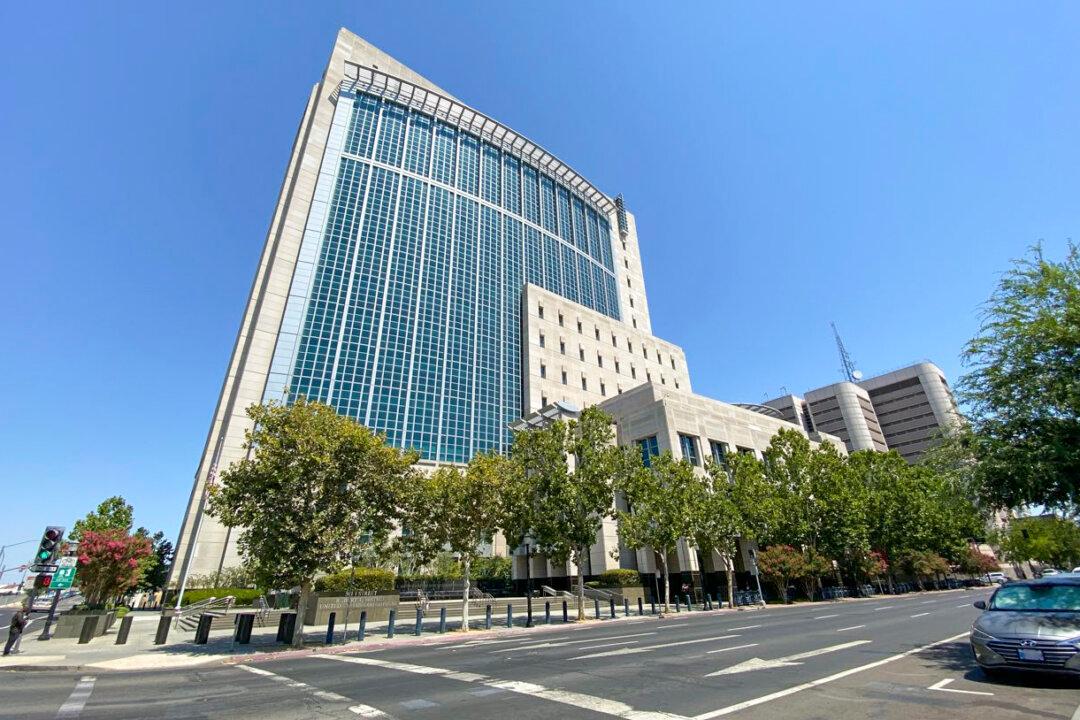 Chinese Fugitive Pleads Not Guilty, Hearing Set for September