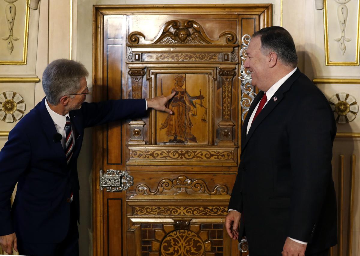 Milos Vystrcil (L), president of the Czech Senate, points to a door as he welcomes U.S. Secretary of State Mike Pompeo in Prague, Czech Republic, on Aug. 12, 2020. (Petr David Josek/AP Photo)