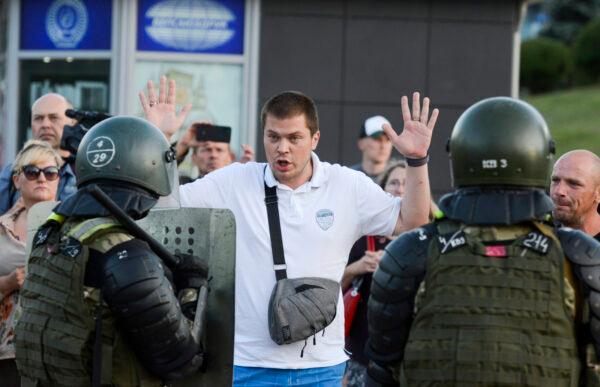 Police detain an opposition supporter protesting the election results as protesters encounter aggressive police tactics in the capital of Minsk, Belarus, on Aug. 11, 2020. (AP Photo)