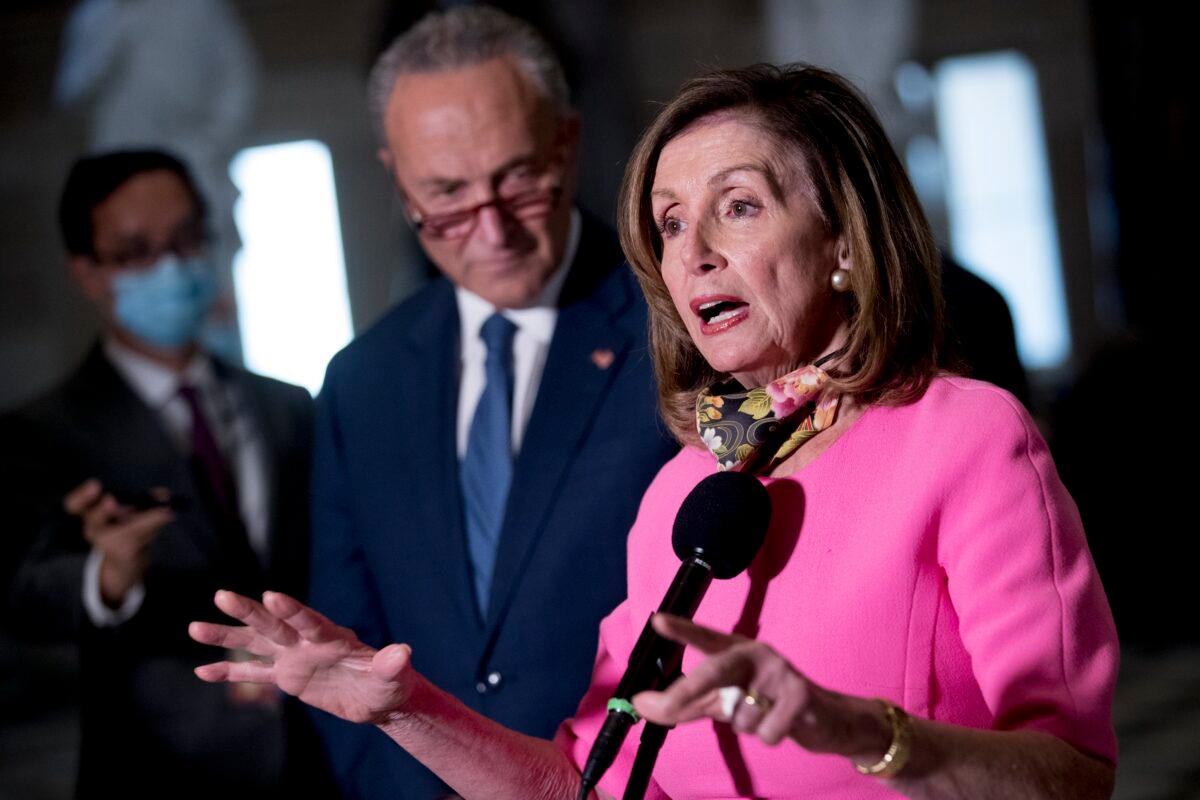 House Speaker Nancy Pelosi (D-Calif.) center, accompanied by Senate Minority Leader Chuck Schumer (D-N.Y.), speak to reporters following a meeting with Treasury Secretary Steven Mnuchin and White House Chief of Staff Mark Meadows as they continue to negotiate a CCP virus relief package on Capitol Hill in Washington on Aug. 7, 2020. (Andrew Harnik/AP Photo)