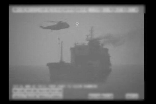 In this image made from video released by the U.S. military's Central Command, Iranian commandos fast-rope down from a helicopter onto the MV Wila oil tanker in the Gulf of Oman off the coast of the United Arab Emirates on Aug. 12, 2020. (U.S. military's Central Command via AP)
