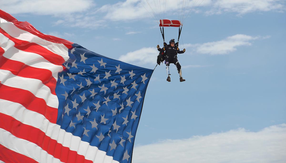 Double Amputee Ex-Green Barret Parachutes In With Giant US Flag at Veterans’ Rally