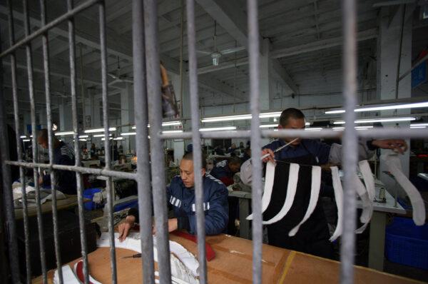 Inmates work in a sewing workshop at a prison in Chongqing Municipality, China on March 7, 2008. (China Photos/Getty Images)