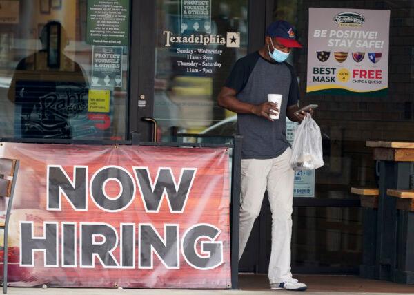 A customer walks past a now hiring sign at an eatery in Richardson, Texas, on Sept. 2, 2020. (LM Otero/AP Photo)