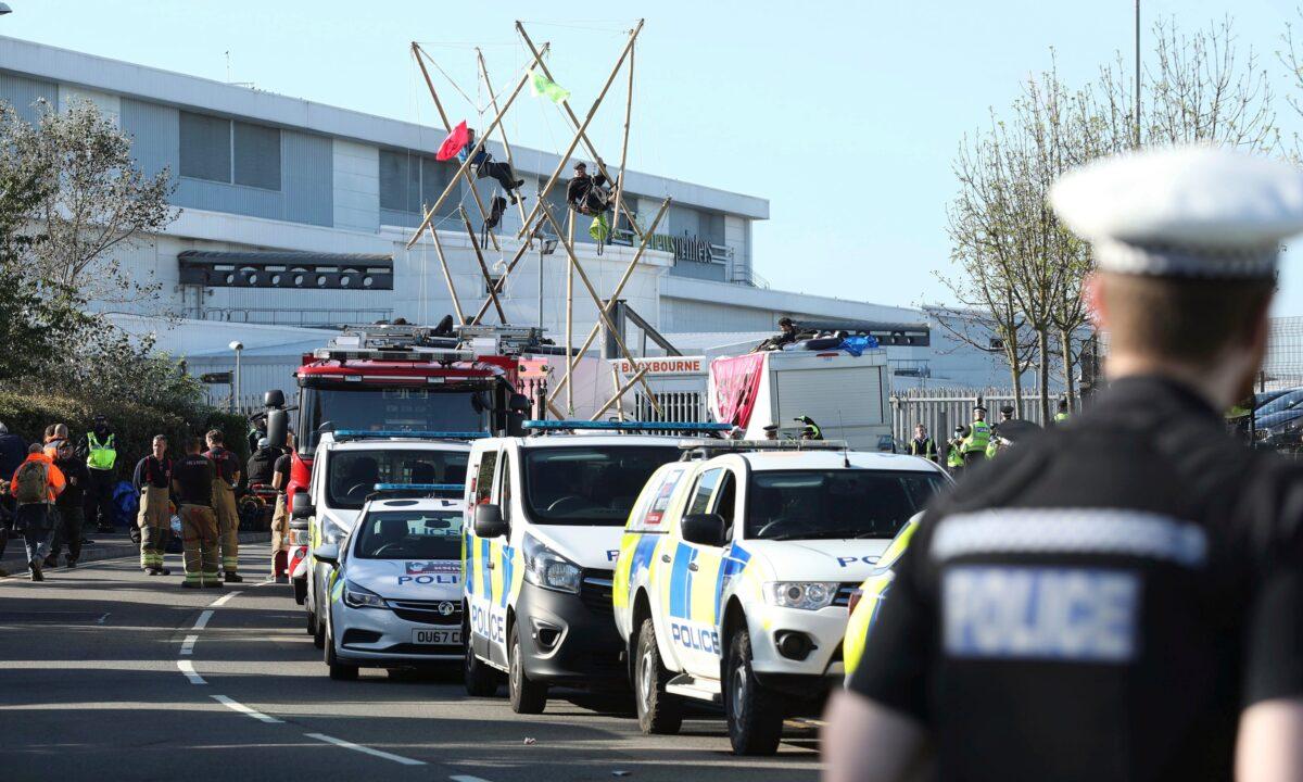 Police and fire services at the scene, outside Broxbourne news printers as protesters continue to block the road, in Broxbourne, Hertfordshire, England, on Sept. 5, 2020. (Yui Mok/PA via AP)
