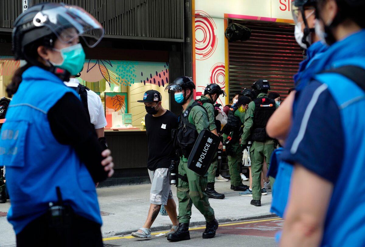 A man is arrested by police officers at a downtown street in Hong Kong, on Sept. 6, 2020. (Vincent Yu/AP Photo)