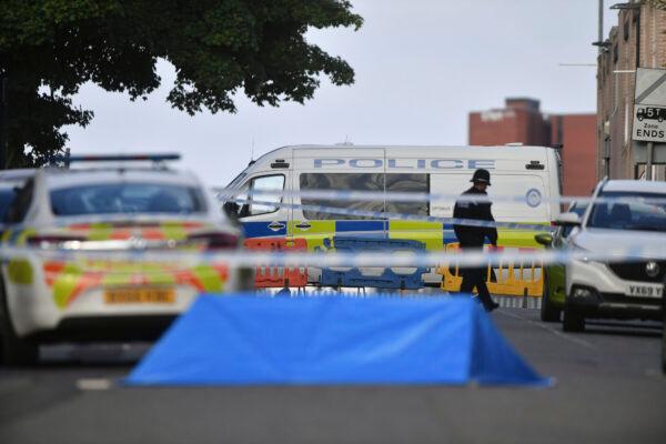 A police officer and vehicles are seen at a cordon in Irving Street in Birmingham after a number of people were stabbed in the city centre, on Sept. 6, 2020. (Jacob King/PA via AP)