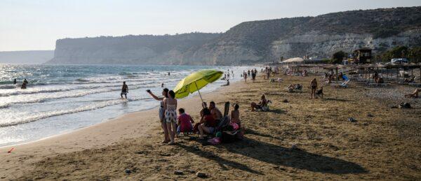 Beach-goers pose together for a "selfie" photo on a cell phone at the Mediterranean beach of Kourion along Episkopi bay, west of Limassol in southwestern Cyprus, on Aug. 25, 2020. (AMIR MAKAR/AFP via Getty Images)