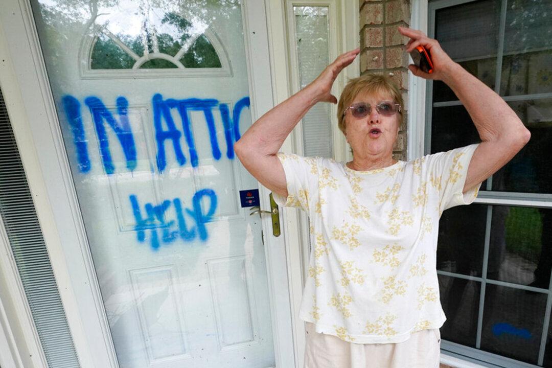 ‘In Attic Help’: Elderly Couple and Their Two Dogs Are Rescued From Storm Sally by Water