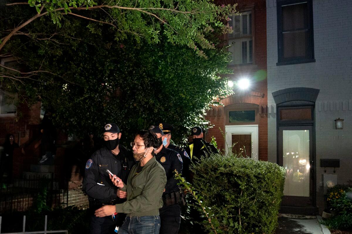 Police escort a protester away from the residence of Sen. Lindsey Graham (R-S.C.) in Washington on Sept. 21, 2020. (Stefani Reynolds/Getty Images)