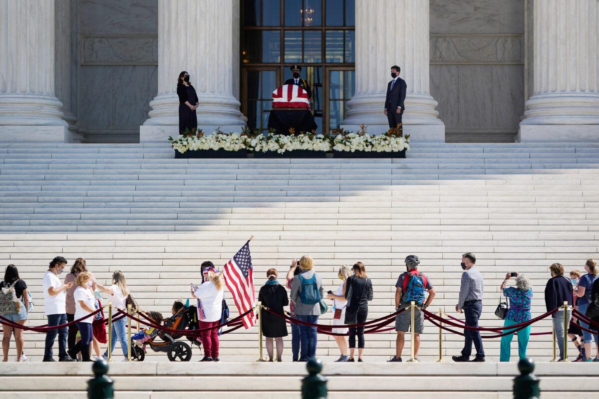 People pay respects as Justice Ruth Bader Ginsburg lies in repose under the Portico at the top of the front steps of the Supreme Court building in Washington on Sept. 23, 2020. (J. Scott Applewhite/AP Photo)