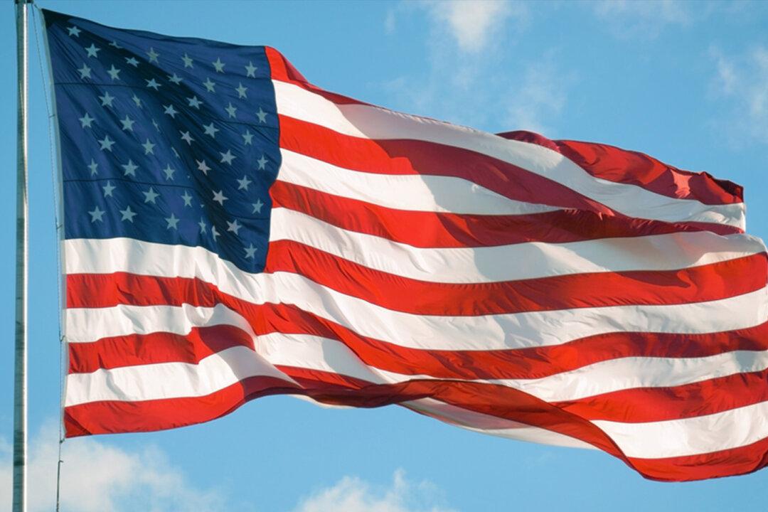 Patriotic Police Officer Caught on Door Cam Rolling Up Fallen US Flag, and the Video Goes Viral