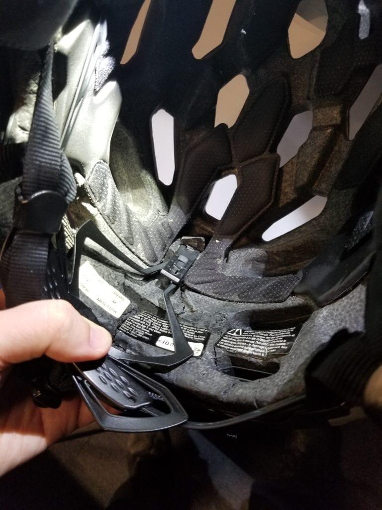 A police officer struck by a rioter's baseball bat holds his cracked helmet, in Seattle, Ore., on Sept. 23, 2020. (Seattle Police Department)