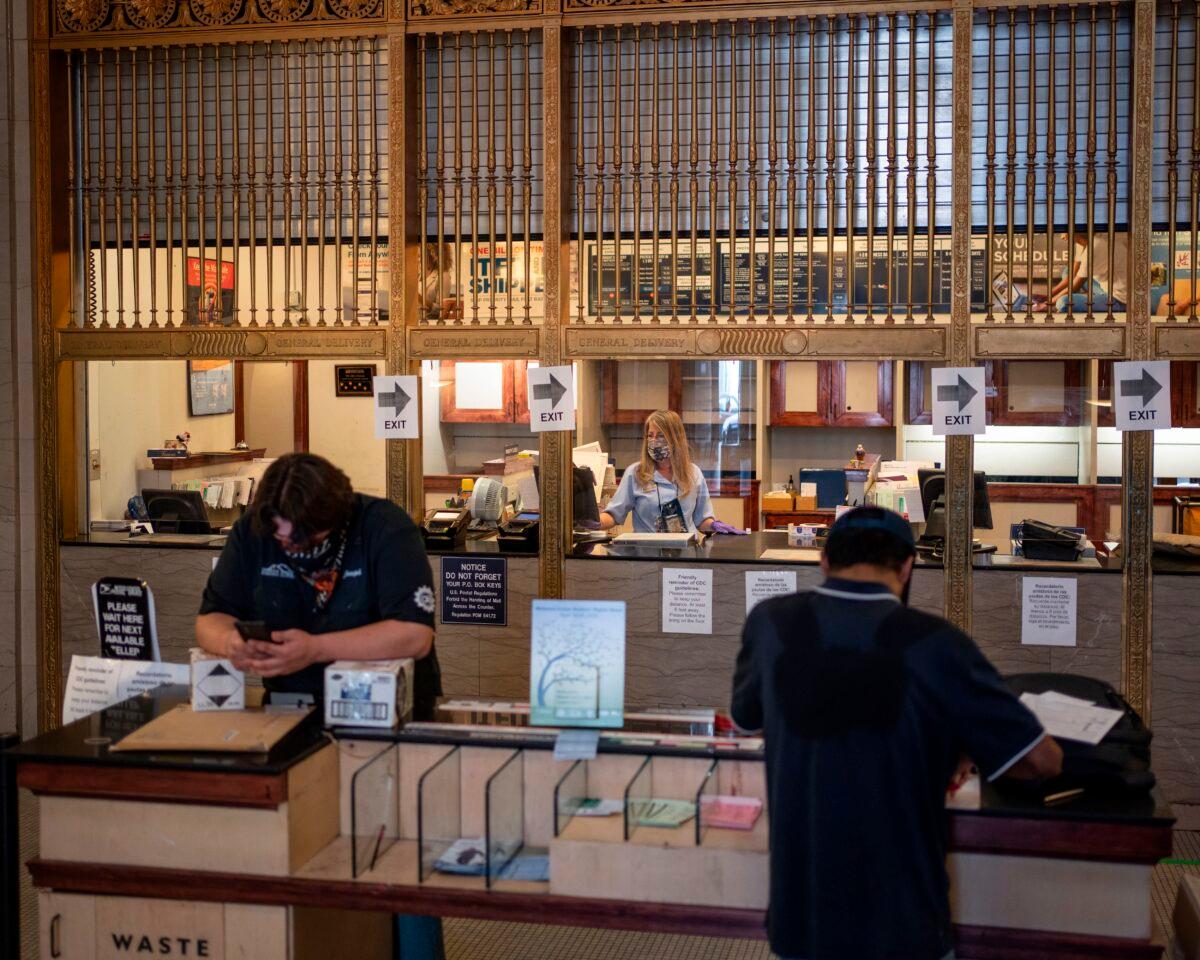 Customers prepare packages at the downtown El Paso United States Postal Service Post Office in El Paso, Texas, on April 30, 2020. (Paul Ratje/AFP via Getty Images)