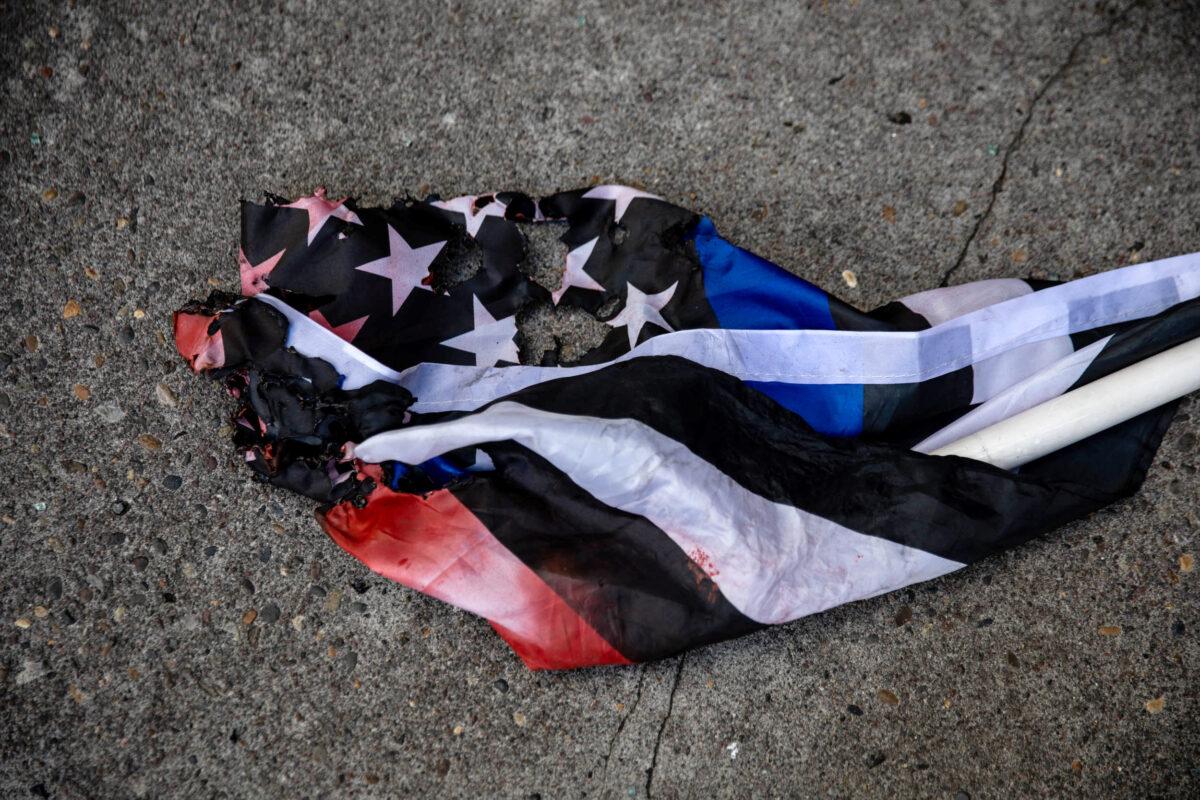 A flag used by Proud Boys and Patriot Prayer is seen on the sidewalk following clashes with counter-demonstrators, including members of Antifa, in Portland, Ore., Aug. 22, 2020. (Maranie Staab/Reuters)
