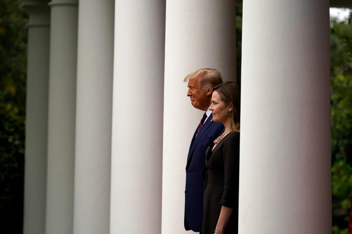 President Donald Trump walks with Judge Amy Coney Barrett to a news conference to announce Barrett as his nominee to the Supreme Court, in the Rose Garden at the White House in Washington on Sept. 26, 2020. (Alex Brandon/AP Photo)