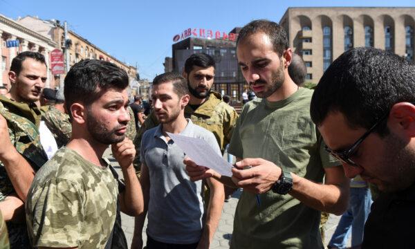 People attend a meeting to recruit military volunteers after Armenian authorities declared martial law and mobilized its male population following clashes with Azerbaijan over the breakaway Nagorno-Karabakh region in Yerevan, Armenia, on Sept. 27, 2020. (Melik Baghdasaryan/Photolure via Reuters)