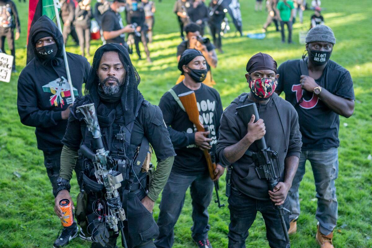 Gun rights activists walk through a counter protest against a nearby Proud Boy rally in Portland, Ore., Sept. 26, 2020. (Nathan Howard/Getty Images)