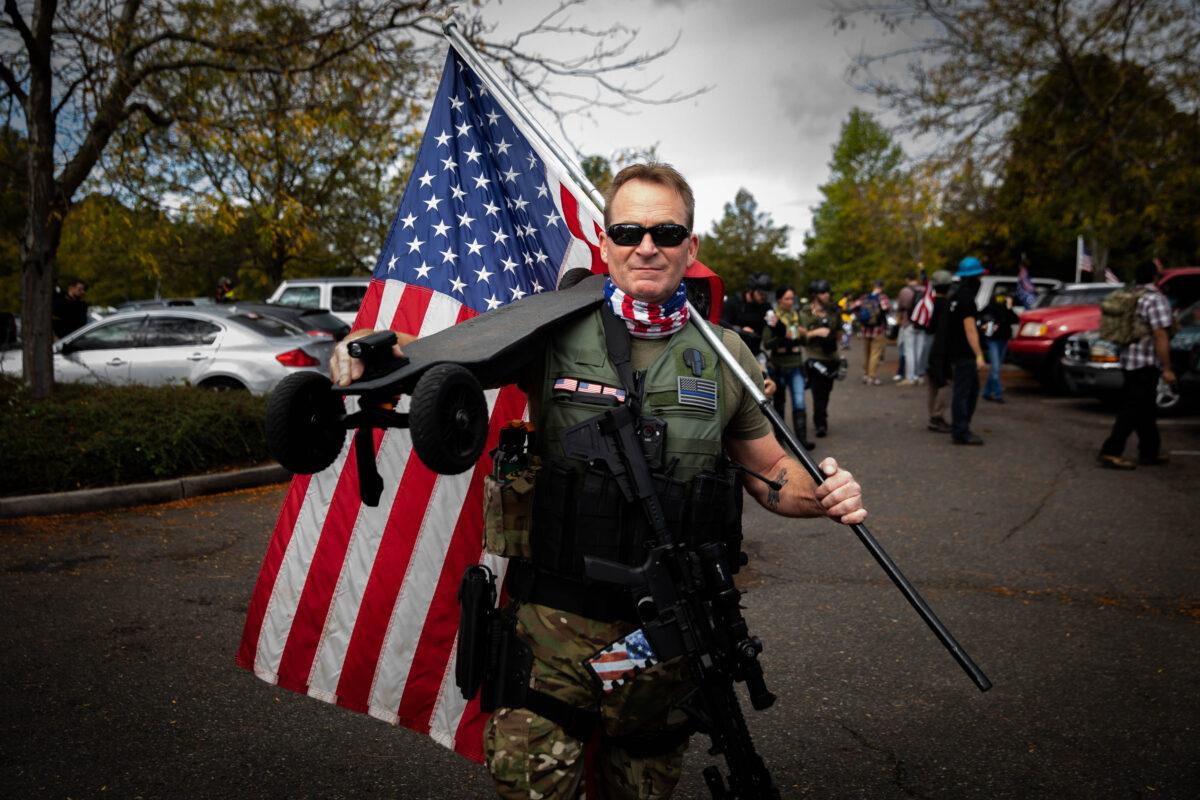 An attendee poses for a picture before listening to organizers speak during a Proud Boys rally at Delta Park in Portland, Ore., on Sept. 26, 2020. (Maranie R. Staab/AFP via Getty Images)