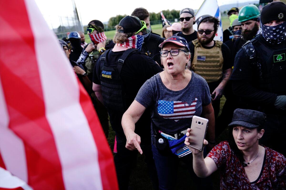 A right-wing demonstrator, center, yells at a counter protester to leave a rally in Portland, Ore., on Sept. 26, 2020. (John Locher/AP Photo)