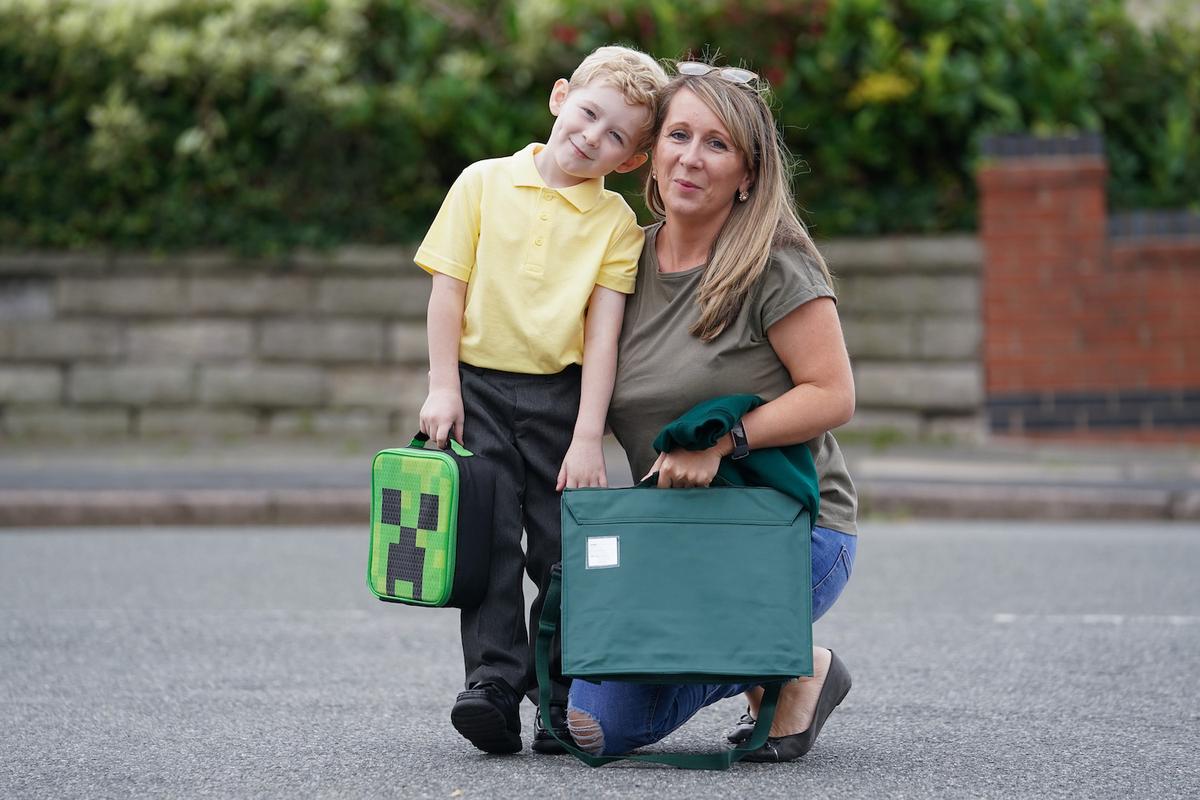 Harry Garside, 5, in his school uniform with his mom, Laura. (Caters News)