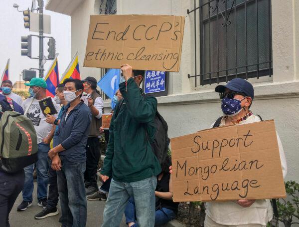 People hold signs at the Chinese Consulate in San Francisco on Oct. 1, 2020, to protest against the CCP’s persecution of minorities. (Ilene Eng/The Epoch Times)