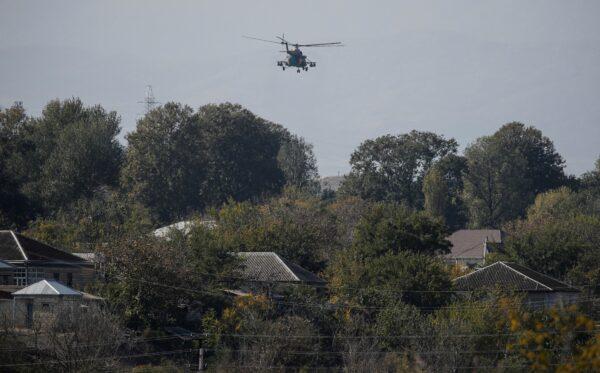 An Azerbaijani military helicopter flies during the fighting over the breakaway region of Nagorno-Karabakh near the city of Terter, Azerbaijan, on Oct. 23, 2020. (Umit Bektas/Reuters)