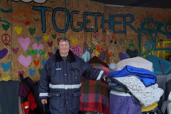 A homeless woman named Starrla Hagerty occupies the space in front of a boarded-up store on 22nd Avenue in Kenosha, Wis., on Nov 10, 2020. (Cara Ding/The Epoch Times)
