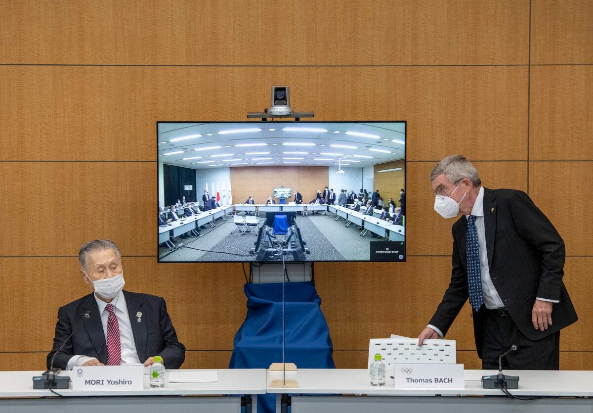 International Olympic Committee President Thomas Bach (R) leaves after attending a press conference with Tokyo 2020 President Yoshiro Mori (L), in Tokyo on Nov. 16, 2020. (Carl Court/Getty Images)