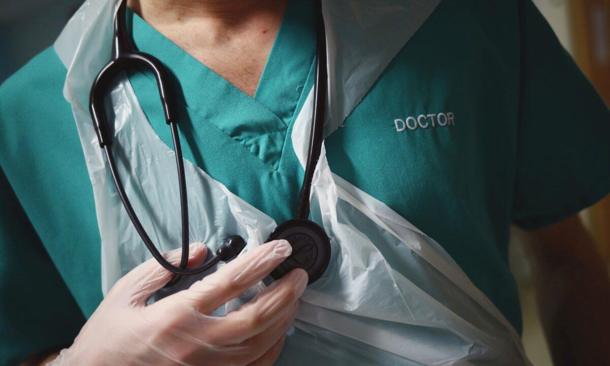 Junior Doctor holds his stethoscope during a patient visit, at The Royal Blackburn Teaching Hospital in East Lancashire, in Blackburn, England, on May 14, 2020. (Hannah McKay/Pool/Getty Images)