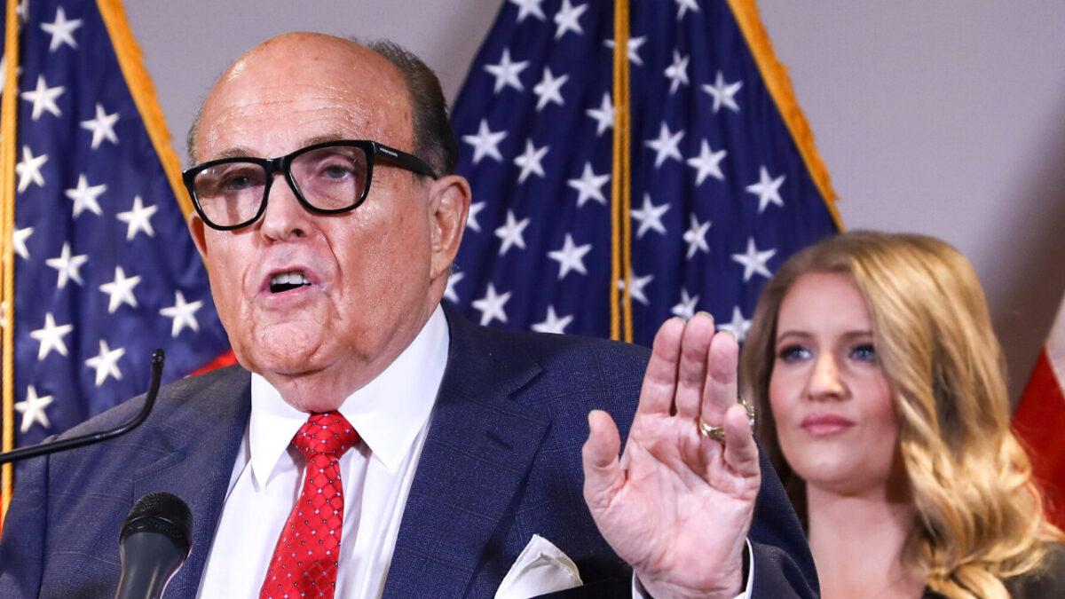 Rudy Giuliani, President Donald Trump's lawyer and a former New York City mayor, speaks to the media, while flanked by Trump campaign senior legal adviser Jenna Ellis (R) at a press conference at the Republican National Committee headquarters in Washington on Nov. 19, 2020. (Charlotte Cuthbertson/The Epoch Times)