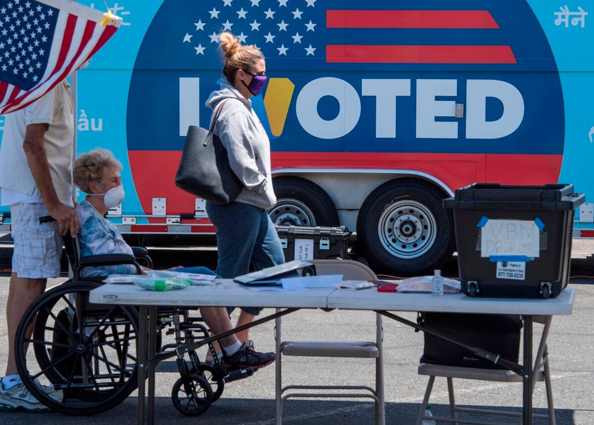 People wait to cast their votes at a polling station in a special election between Democrat state assemblywoman Christy Smith and Republican businessman and ex-Navy pilot Mike Garcia for the vacant 25th Congressional District, in Santa Clarita, Calif., on May 12, 2020. (Mark Ralston/AFP/Getty Images)