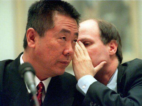 Former Democratic Party fundraiser Yah Lin "Charlie" Trie (L) listens to his attorney William Hassler during his testimony to members of the U.S. House Government Reform Committee on Capitol Hill, Washington, on March 1, 2000. (George Bridges/AFP via Getty Images)