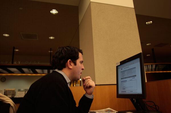 Paul Costiglio looks over job listings at a computer in the Science, Industry, and Business branch of the New York Public Library, where he does job hunting research in New York City on Dec. 8, 2008. (Chris Hondros/Getty Images)