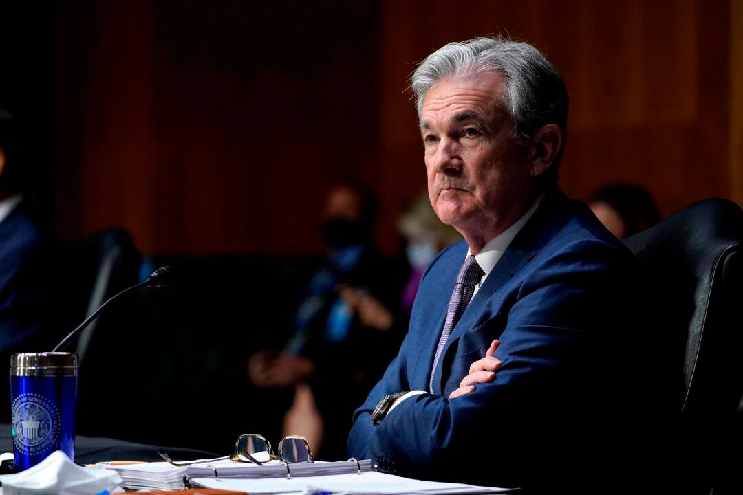 Fed Holds Interest Rates Near Zero, Boosts Economic Projections