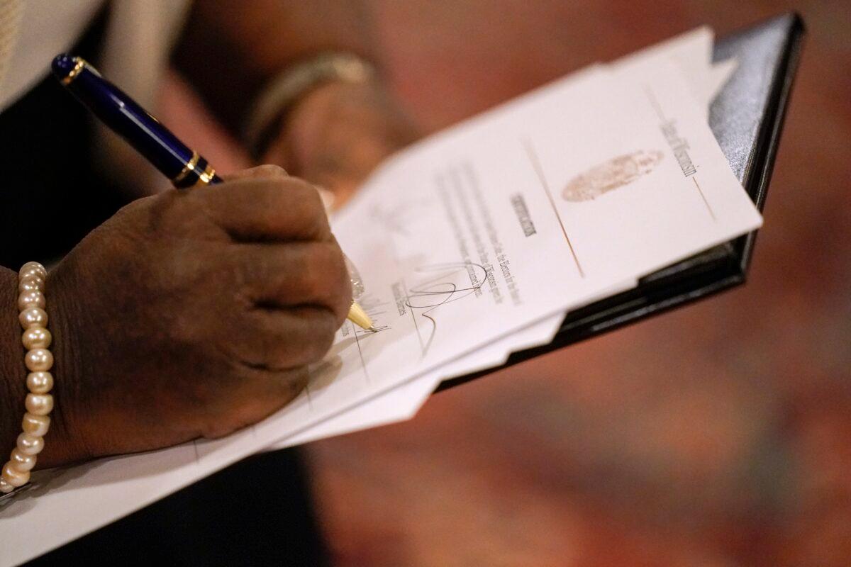 A member of Wisconsin's Electoral College casts their vote for the presidential election at the state Capitol in Madison, Wis, on Dec. 14, 2020. (Morry Gash/Pool/Getty Images)
