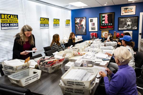 Volunteers sort recall mail, hoping to oust California Gov. Gavin Newsom at Capital Campaigns Inc. in Newport Beach, Calif., on Jan 4, 2021. (John Fredricks/The Epoch Times)