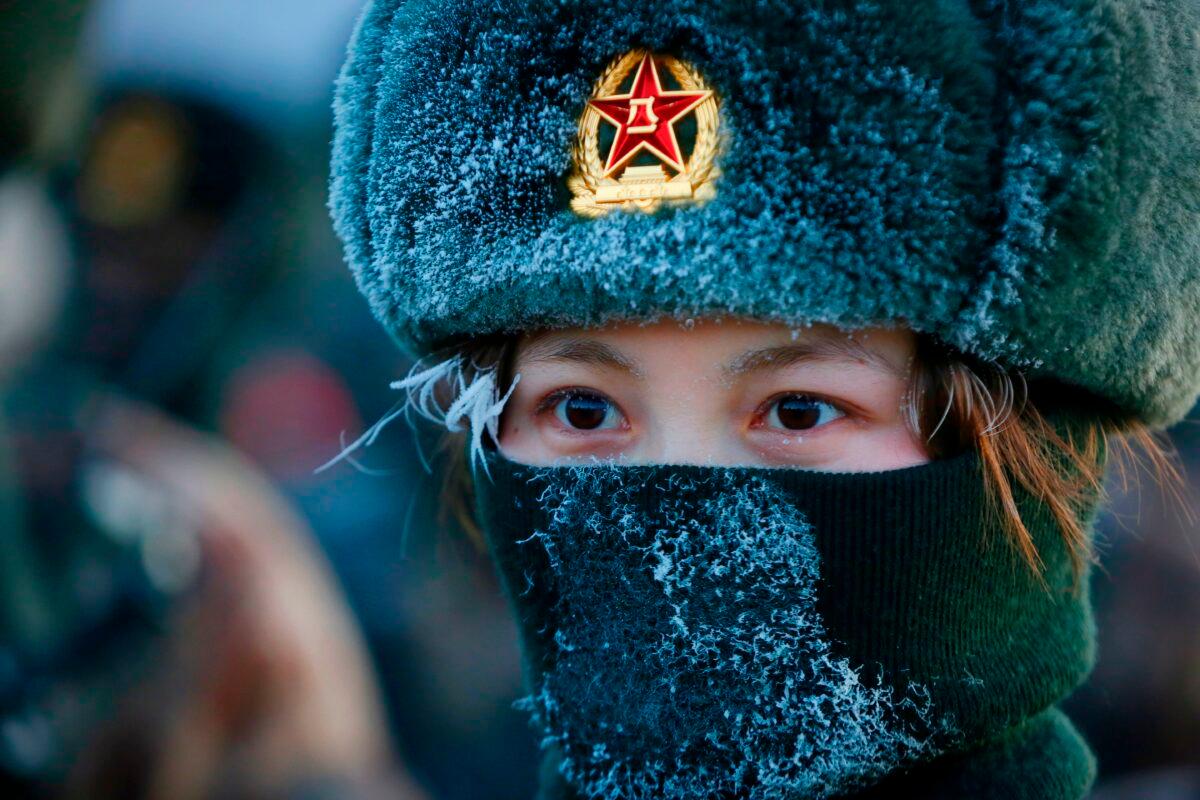 A female Chinese People’s Liberation Army (PLA) soldier takes military training at the Pamir Mountains in Kashgar, northwestern China’s Xinjiang region on Jan. 4, 2021. (STR/AFP via Getty Images)