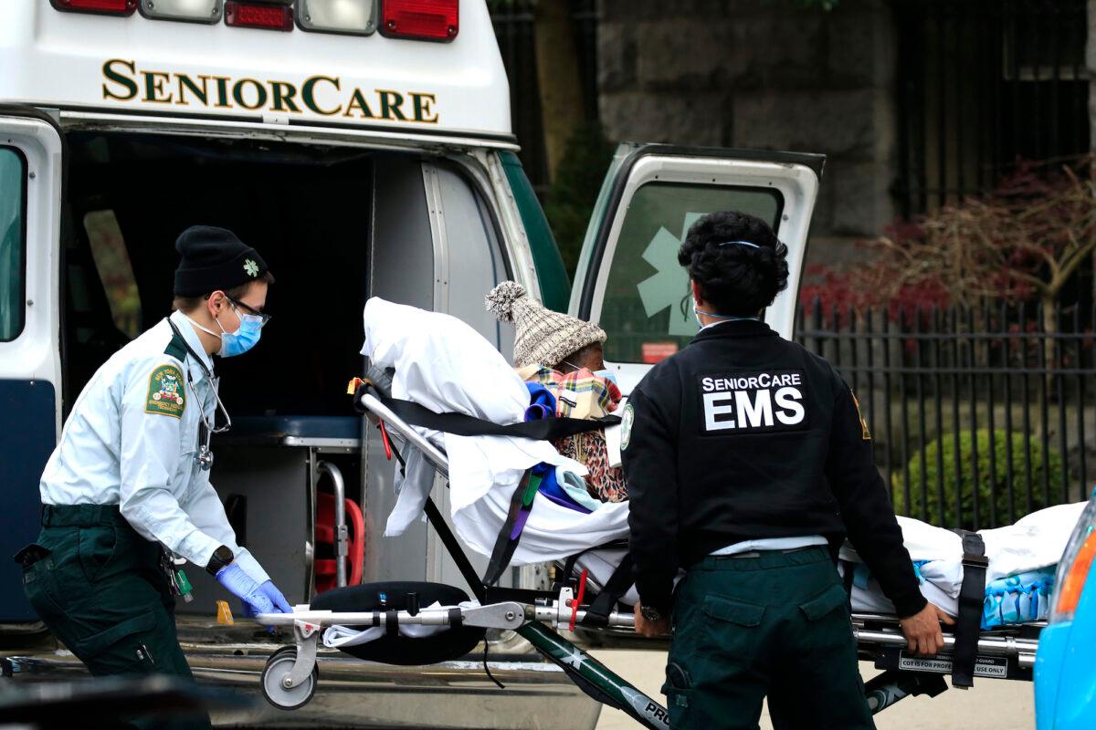 Emergency medical workers unload a patient outside a nursing home in Brooklyn, N.Y., on April 18, 2020. (Justin Heiman/Getty Images)