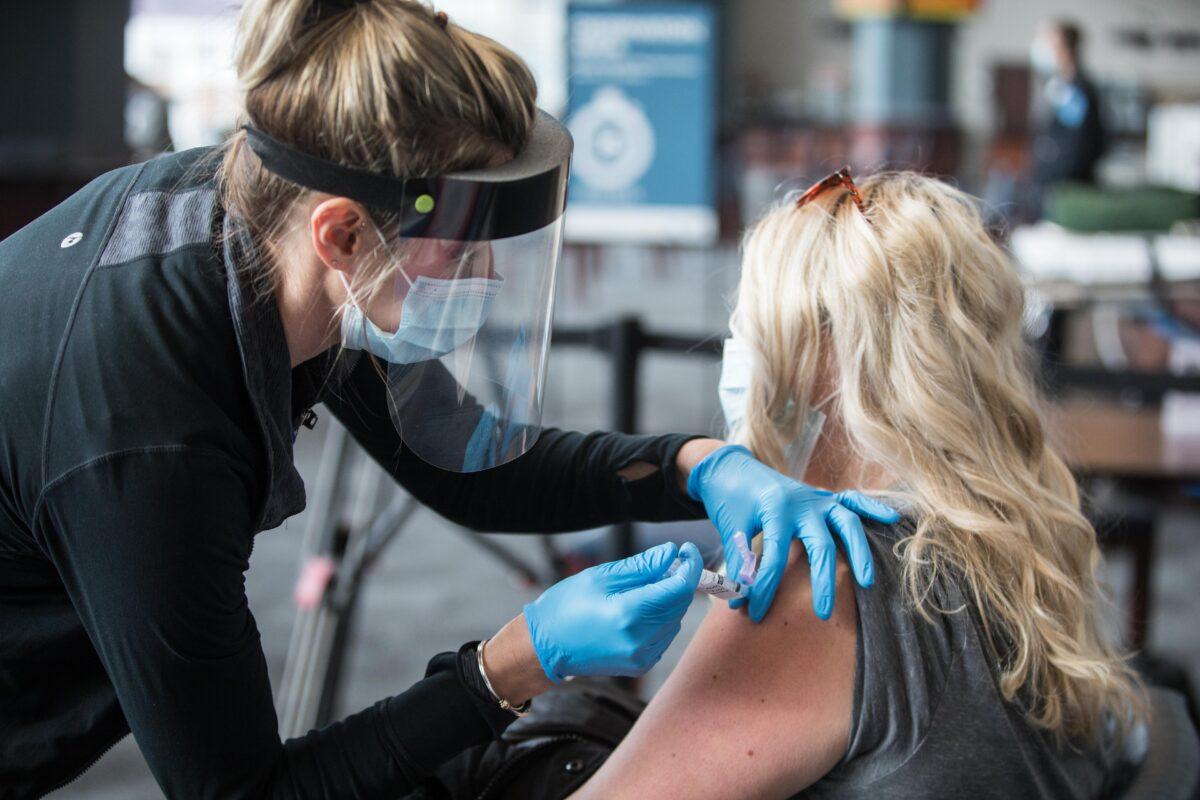 A woman receives a COVID-19 vaccine at Gillette Stadium in Foxborough, Mass., on Jan. 15, 2021. (Scott Eisen/Getty Images)