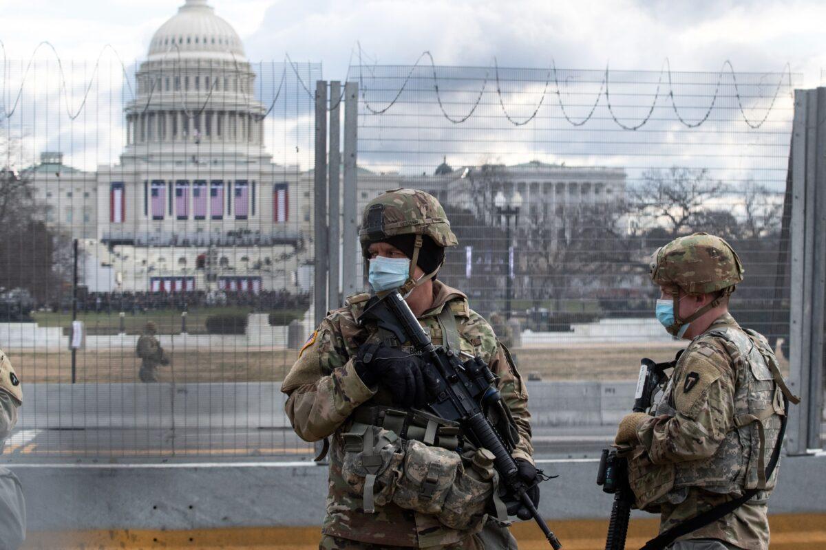 U.S. National Guard troops patrol the vicinity of the U.S. Capitol hours before the Inauguration of President Joe Biden in Washington on Jan. 20, 2021. (Roberto Schmidt/AFP via Getty Images)